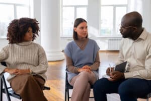 Participants sharing emotions during intervention services in New Jersey support meeting