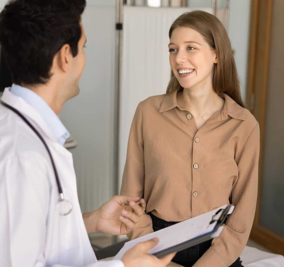 Patient smiling with doctor during drug addiction treatment in Greensboro NC consultation