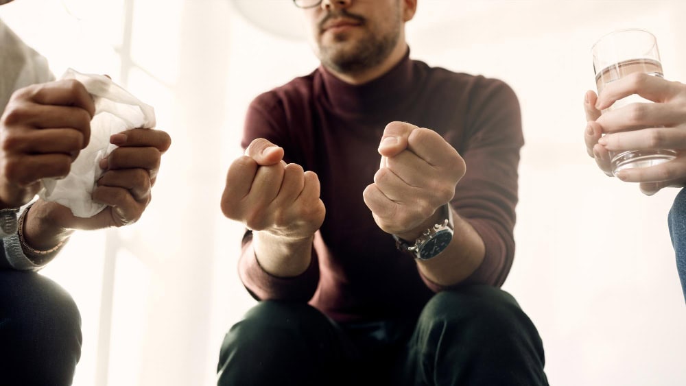 Closeup of group therapy during addiction programs in Greensboro.