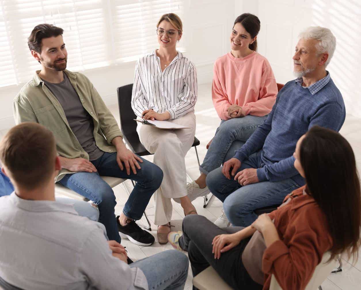 Group therapy session with clients seated in a circle at 1Eleven.