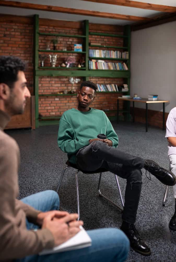Group therapy session at drug rehab in Greensboro North Carolina with participants sharing