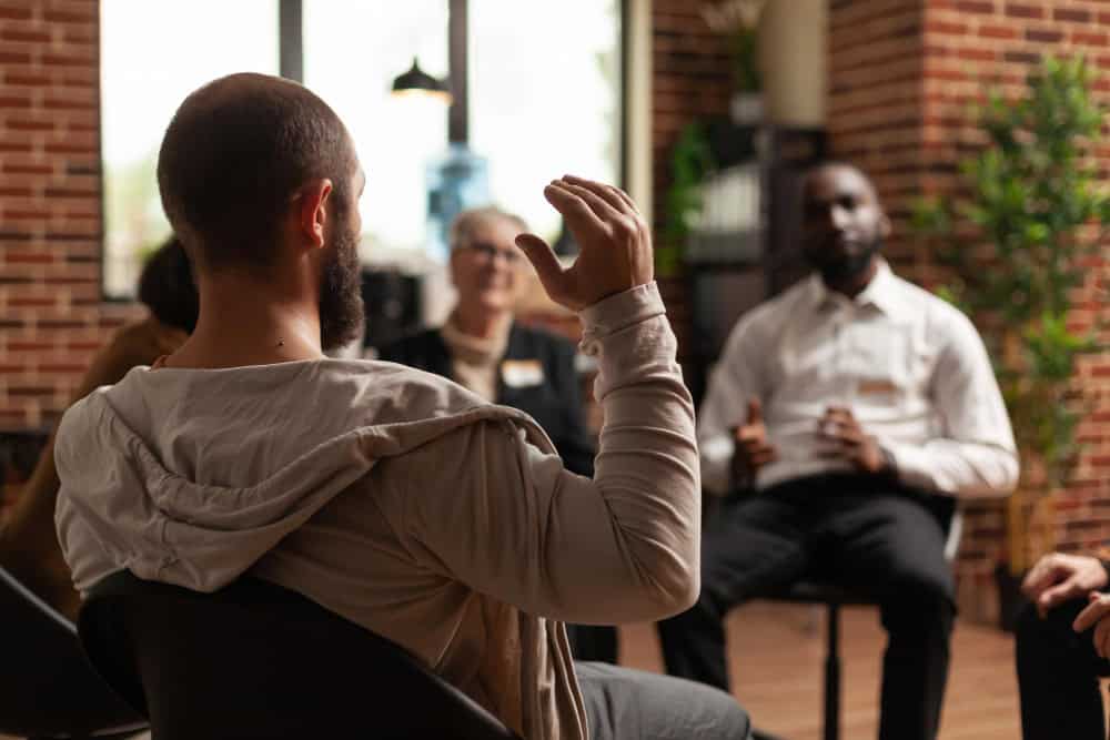 Man sharing experiences during group session in mental health PHP in Greensboro NC program