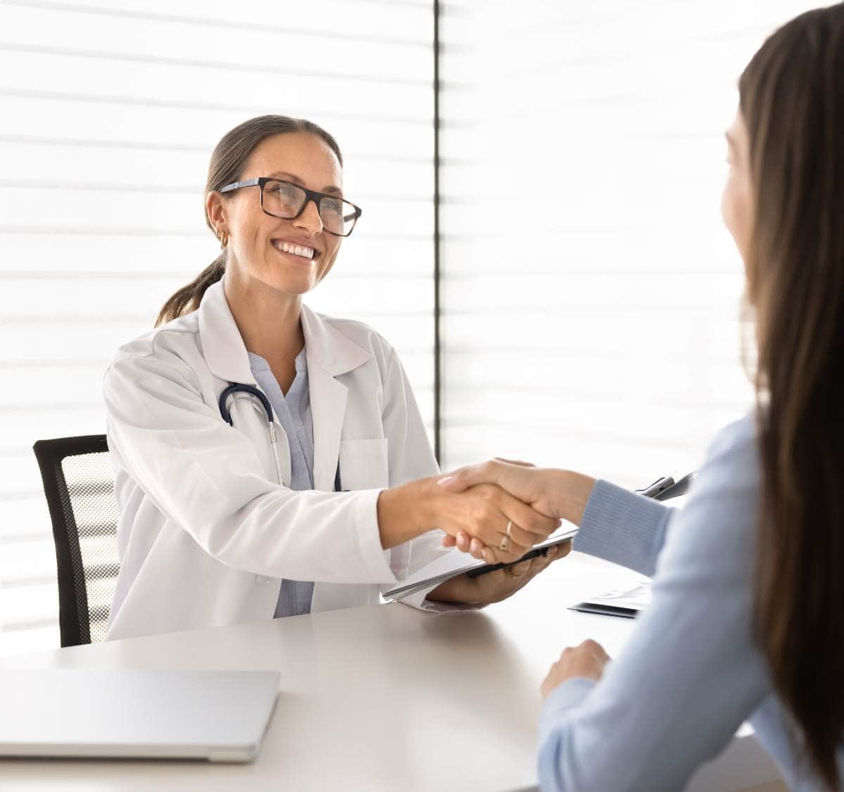 Doctor greets a patient in clinic.