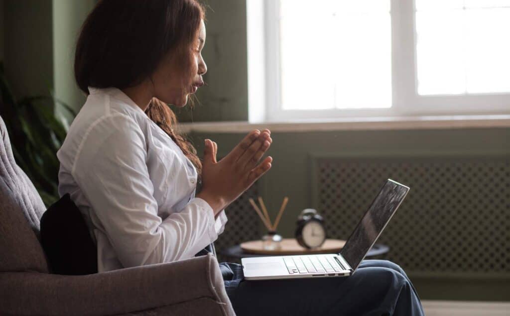 Woman speaking with a therapist during virtual addiction treatment in Greensboro, NC.