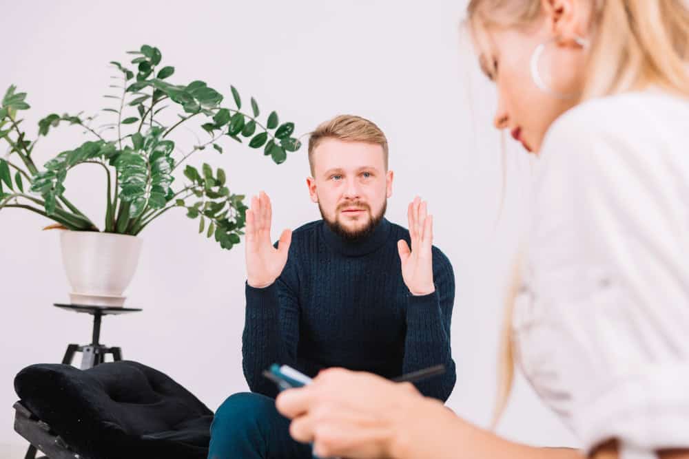 Young woman discussing her concerns with a therapist during bipolar disorder therapy in Greensboro, NC.