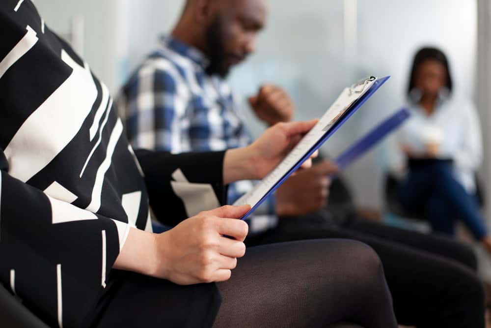 Woman holding a notebook while preparing for Xanax rehab in Greensboro, NC at 1Eleven Behavioral Health.
